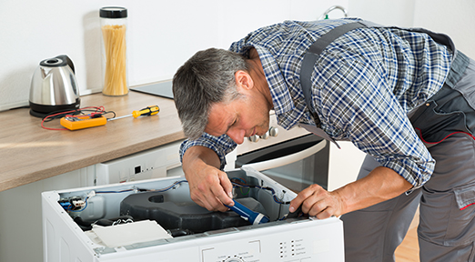 Repair technician fixing an appliance